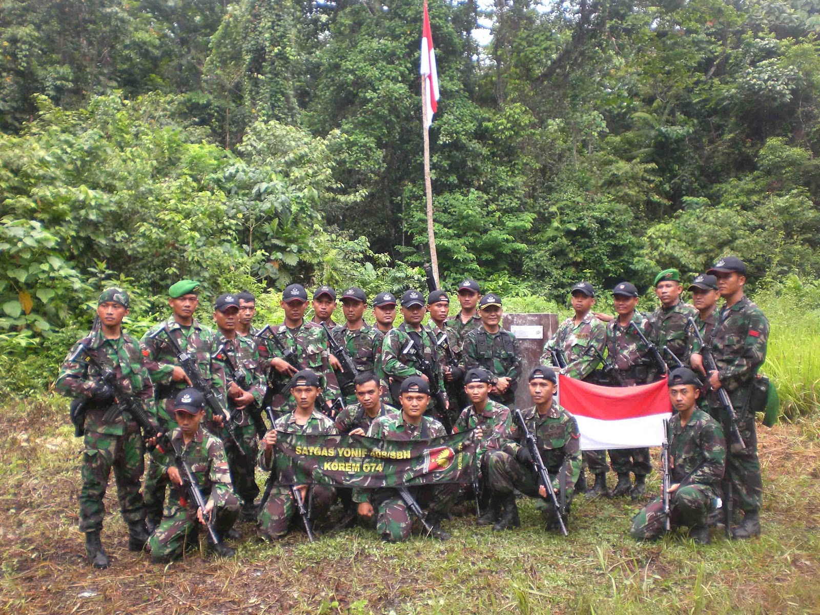 Indonesian soldiers posting for a photo just meters in front of the PNG border