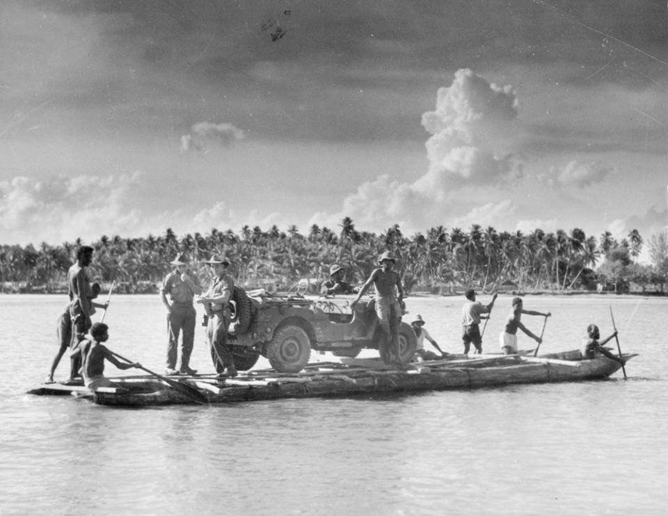 "Fuzzy Wuzzy Angels" in Wets Papua guiding an Australian army jeep down a river on their traditional boat 